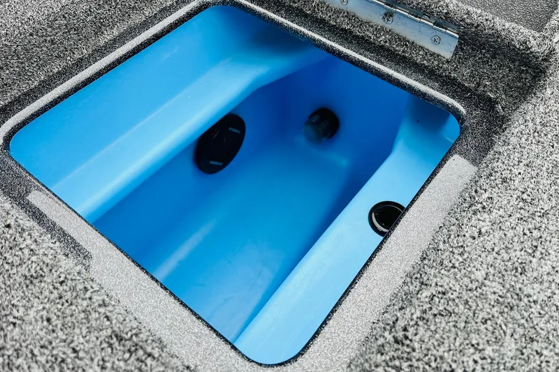 Slide: The Image of 2026 Nitro Z21 XL Pro boat livewell with blue interior and textured gray exterior. - 110