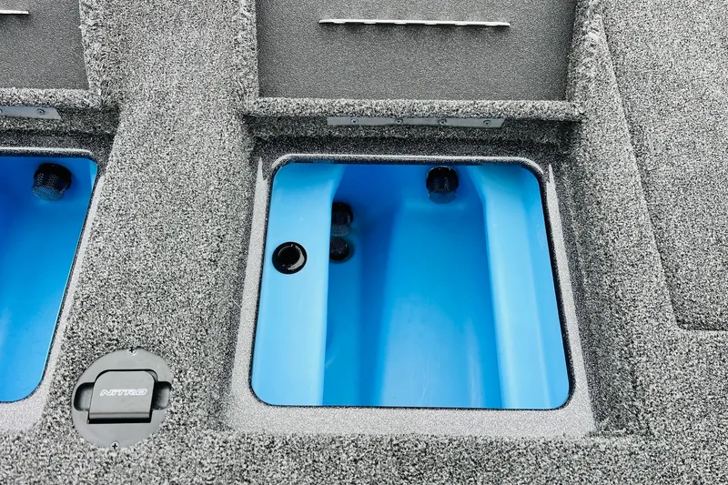 Slide: The Image of 2026 Nitro Z21 XL Pro boat storage compartment with blue interior and textured gray exterior. - 111