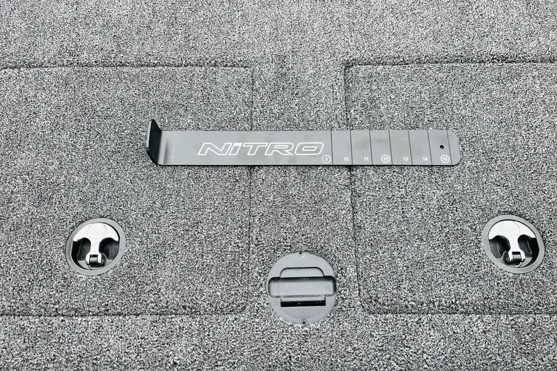 Slide: The Image of 2026 Nitro Z21 XL Pro boat deck with measurement tool and storage compartments. - 113