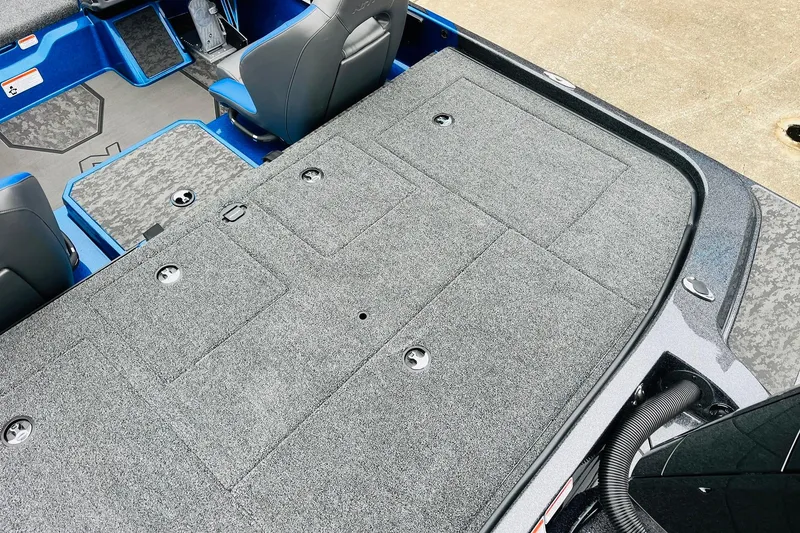 Slide: The Image of 2026 Nitro Z21 XL Pro boat interior with gray carpeted deck and blue accents. - 118