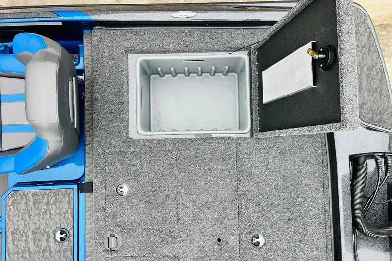 Slide: The Image of 2026 Nitro Z21 XL Pro boat interior with open storage compartment and blue-gray seating. - 120