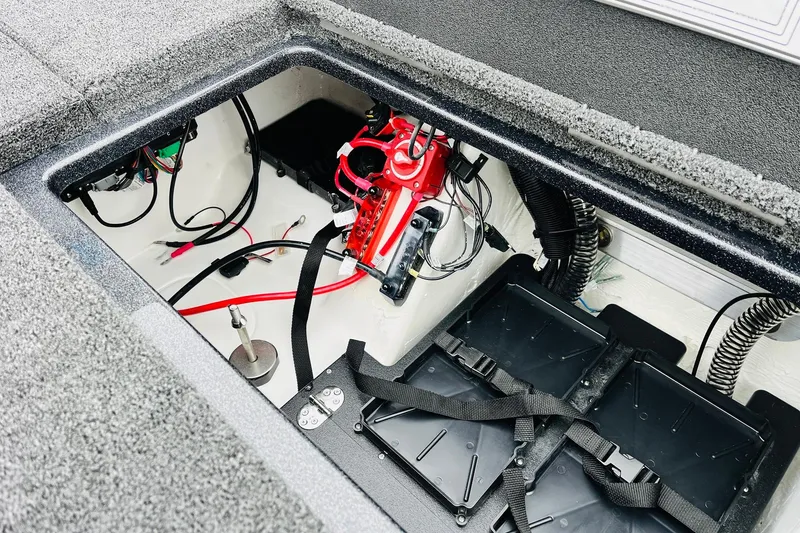 Slide: The Image of 2026 Nitro Z21 XL Pro boat battery compartment with wiring and components. - 124