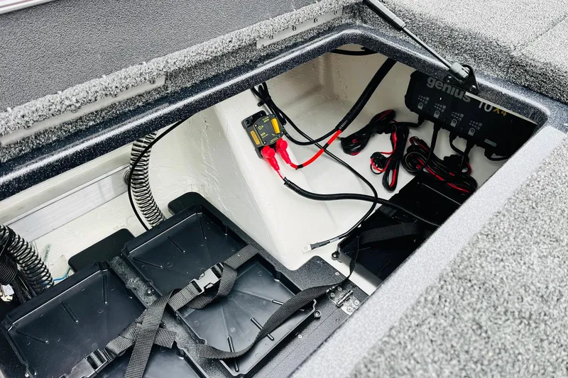 Slide: The Image of 2026 Nitro Z21 XL Pro boat battery compartment with wiring and charger setup. - 125
