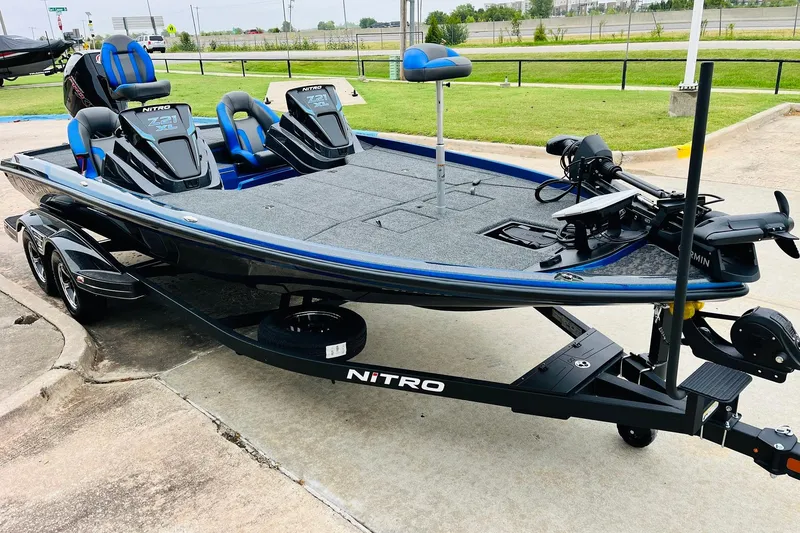 Slide: The Image of 2026 Nitro Z21 XL Pro fishing boat on trailer, featuring blue accents and dual seats. - 60
