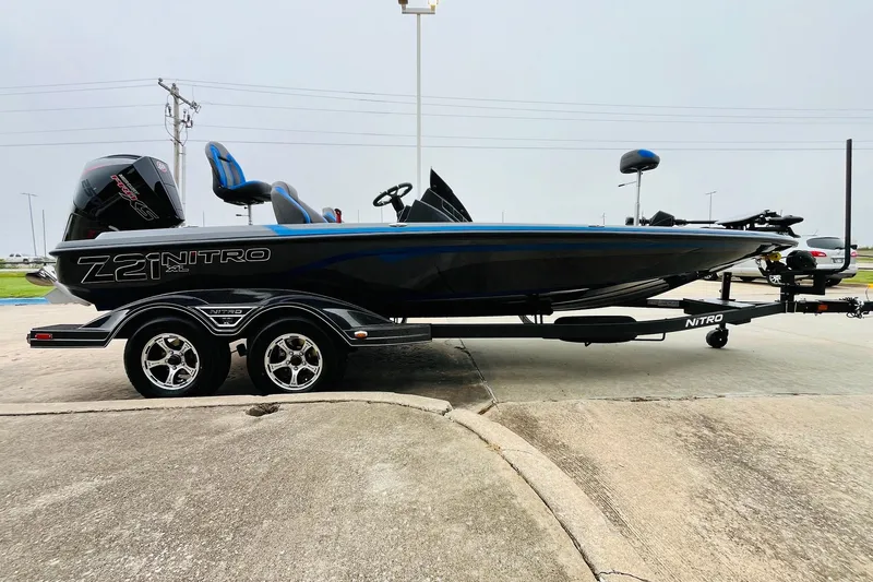 Slide: The Image of 2026 Nitro Z21 XL Pro boat on trailer, sleek design, black and blue accents. - 61