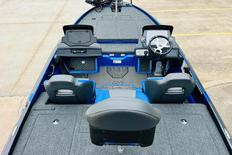 Slide: The Image of 2026 Nitro Z21 XL Pro boat interior with steering wheel and seating, featuring gray and blue accents. - 68