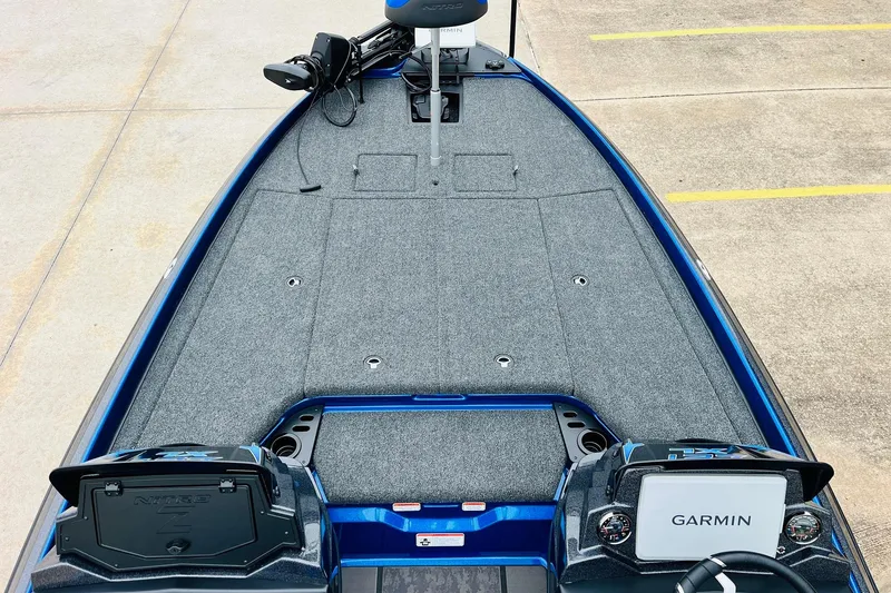 Slide: The Image of 2026 Nitro Z21 XL Pro boat interior with Garmin system, gray carpet, and blue accents. - 69