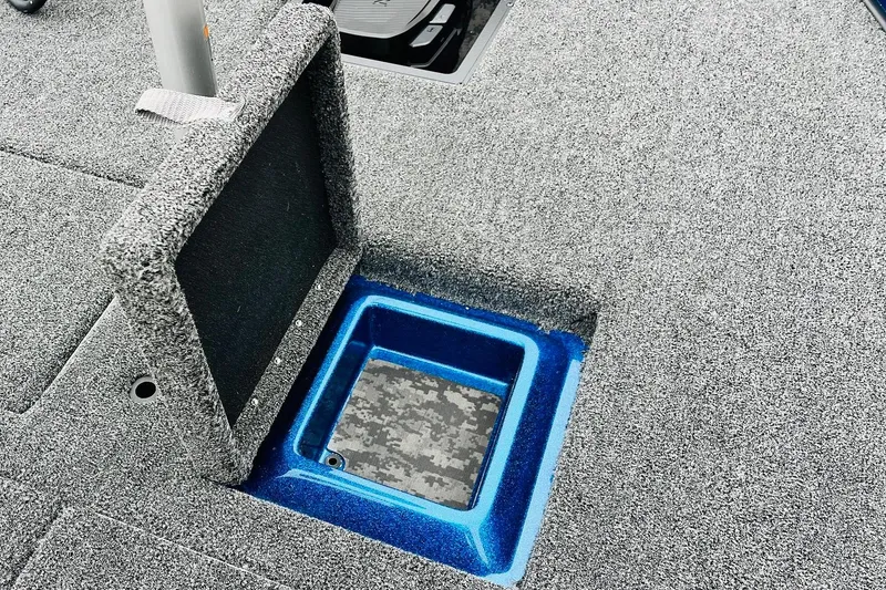 Slide: The Image of 2026 Nitro Z21 XL Pro boat storage compartment with blue trim and carpeted interior. - 80