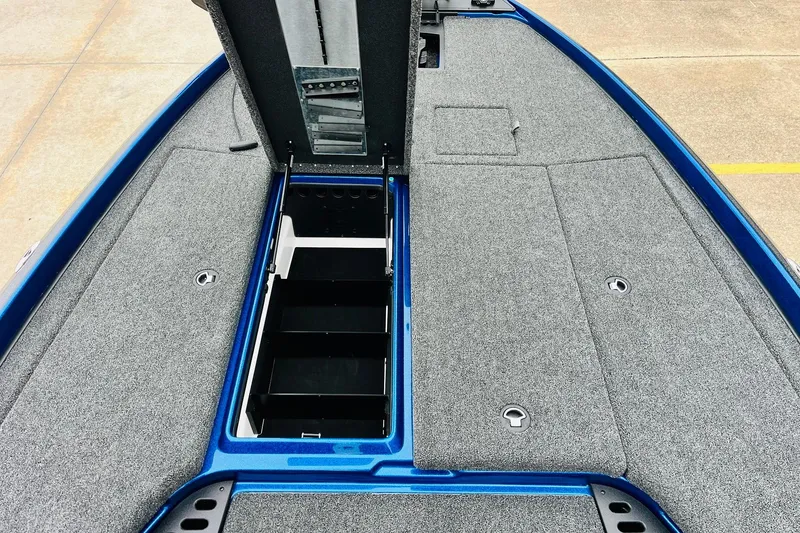 Slide: The Image of 2026 Nitro Z21 XL Pro boat deck with open storage compartments, featuring gray carpeting. - 81