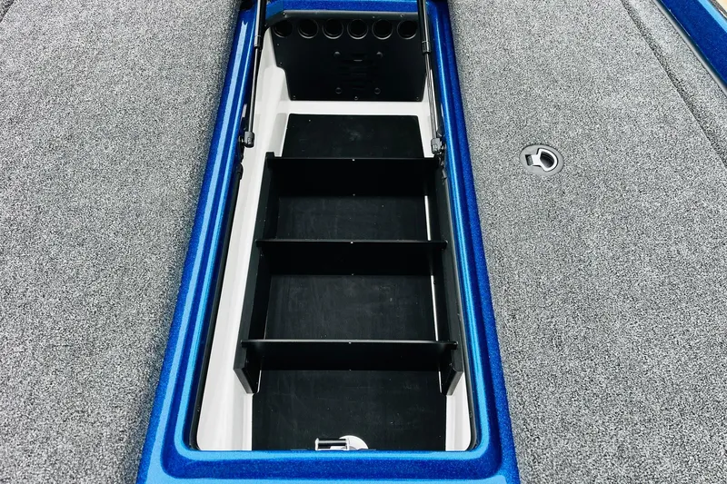 Slide: The Image of 2026 Nitro Z21 XL Pro boat storage compartment with blue trim and carpeted surface. - 84