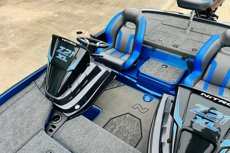 Slide: The Image of 2026 Nitro Z21 XL Pro boat interior with blue and gray seating and sleek design. - 91