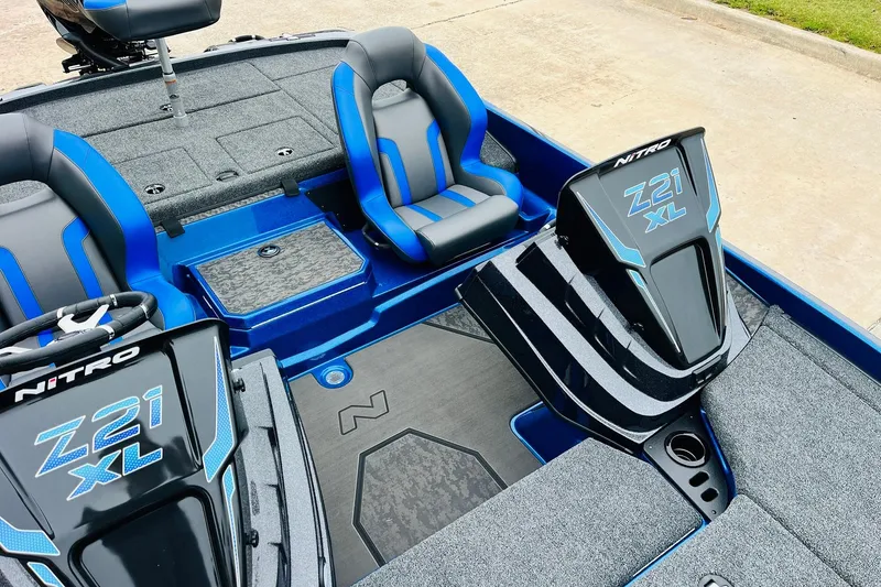 Slide: The Image of 2026 Nitro Z21 XL Pro boat interior with blue and gray seating, sleek design. - 92