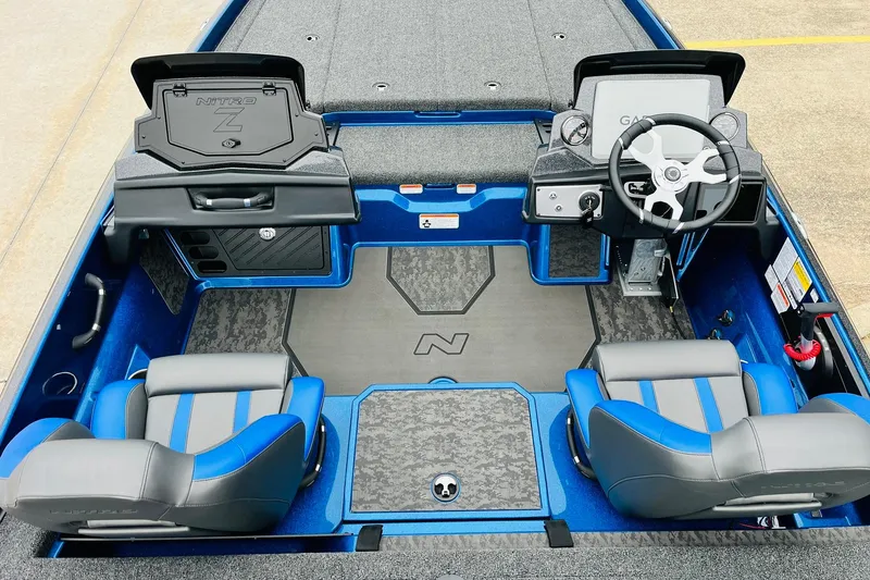 Slide: The Image of 2026 Nitro Z21 XL Pro boat interior with blue and gray seating, steering console, and storage compartments. - 93