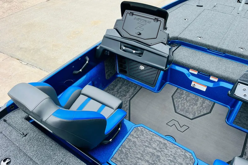 Slide: The Image of 2026 Nitro Z21 XL Pro boat interior with blue and gray seating and storage compartments. - 94