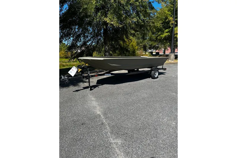 The Image of 2026 Tracker Grizzly 1648 Utility boat on trailer, parked outdoors. - 0