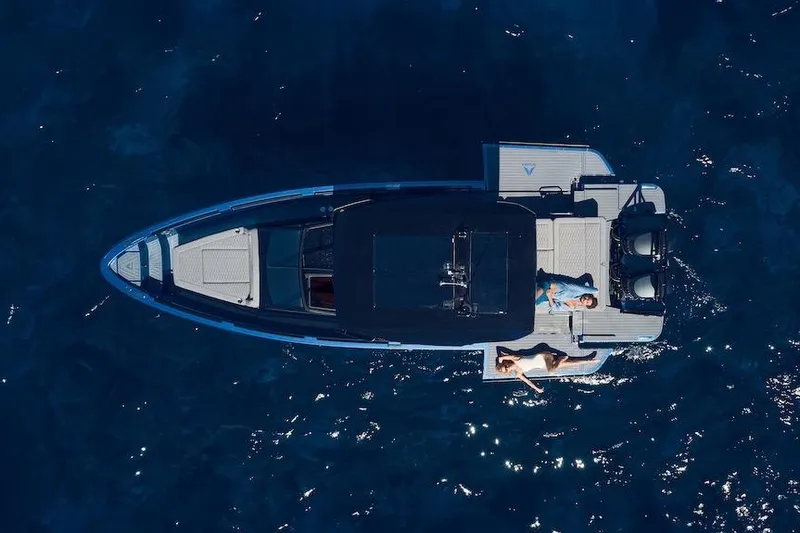 Slide: The Image of Aerial view of 2026 Virtue V10 T-Top boat on sparkling blue water. - 3