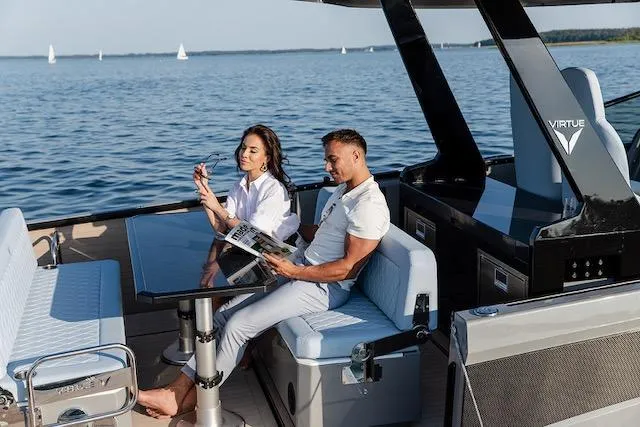 Slide: The Image of Couple relaxing on a 2026 Virtue V10 yacht, enjoying a sunny day on the water. - 5