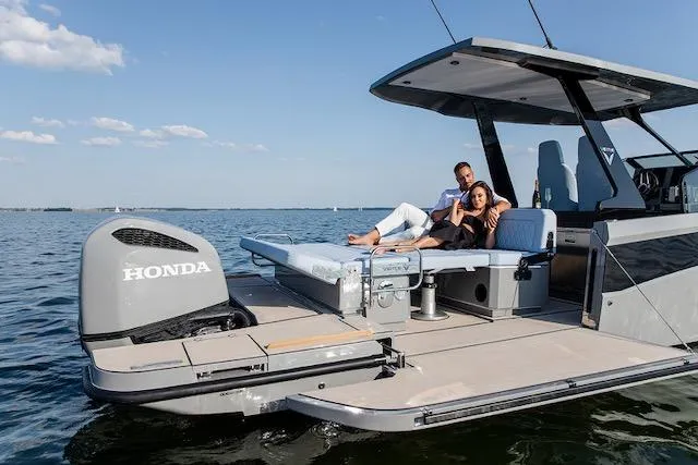 Slide: The Image of Couple relaxing on a 2026 Virtue V10 boat with Honda engine, enjoying a sunny day. - 6