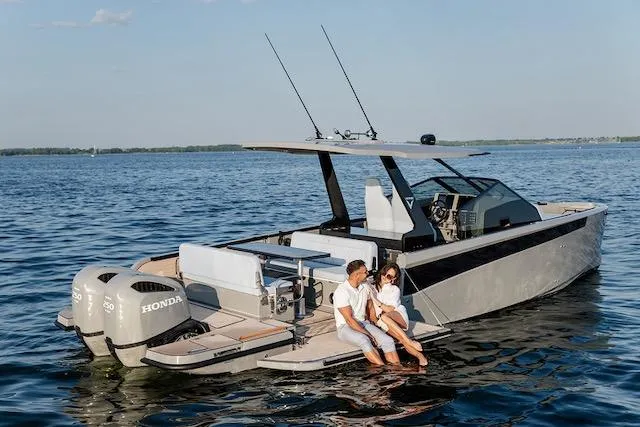Slide: The Image of Couple relaxing on a 2026 Virtue V10 boat with dual Honda engines on a serene lake. - 7