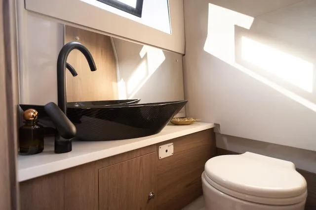 Slide: The Image of Modern bathroom in 2026 Virtue V10 with sleek black fixtures and wooden cabinetry. - 8