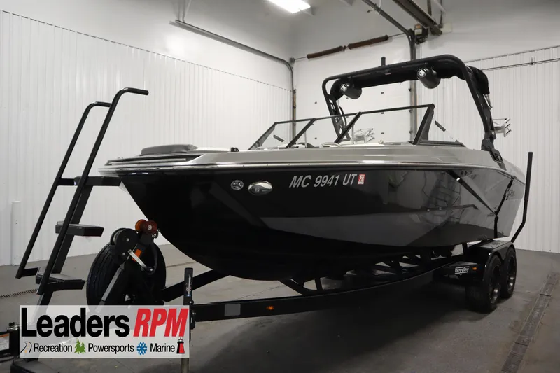 The Image of 2022 Heyday H22 boat on trailer in indoor showroom, Leaders RPM branding visible. - 1