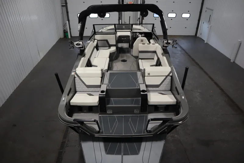 Slide: The Image of 2022 Heyday H22 boat interior with sleek seating and modern design in a garage setting. - 10