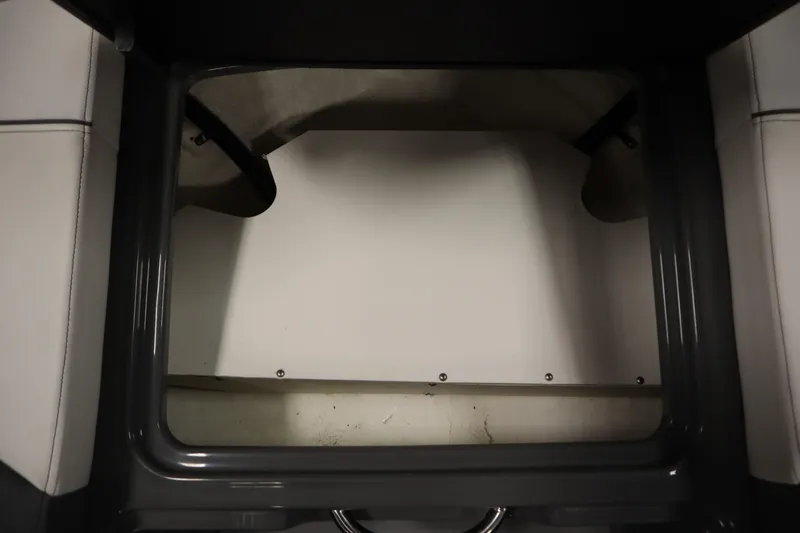 Slide: The Image of 2022 Heyday H22 boat interior storage compartment with gray and white seating. - 13