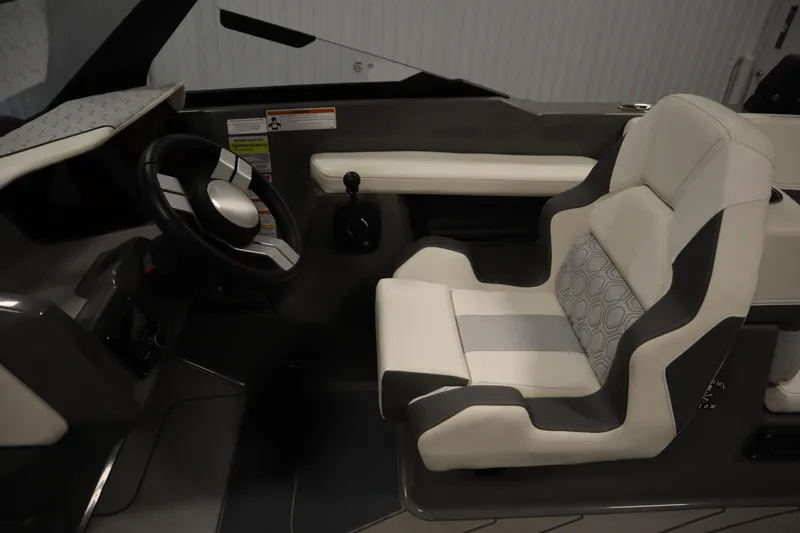 Slide: The Image of 2022 Heyday H22 boat interior with modern steering wheel and cushioned seat. - 19