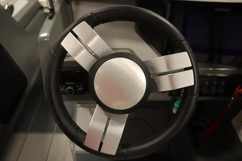 Slide: The Image of Steering wheel of 2022 Heyday H22 boat, featuring sleek metallic design. - 21