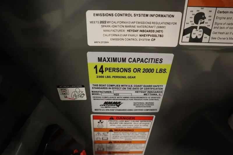 Slide: The Image of Heyday H22 2022 boat capacity label, 14 persons or 2000 lbs, safety compliance details. - 25