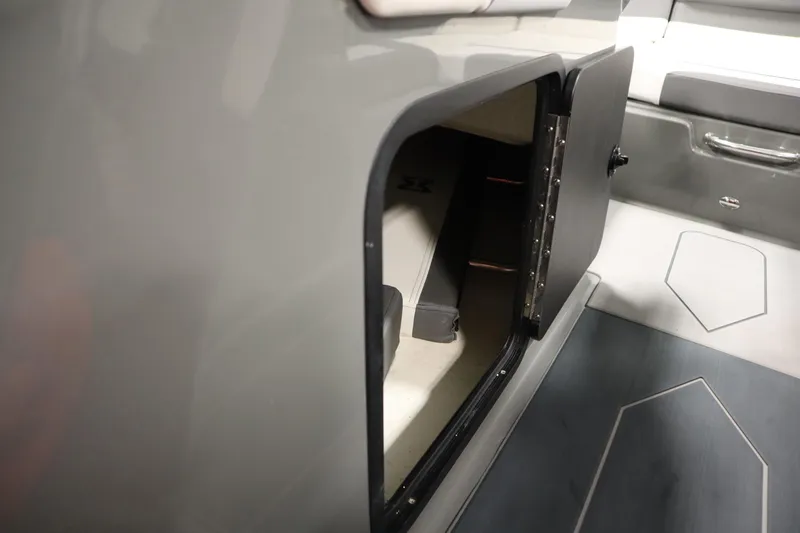 Slide: The Image of 2022 Heyday H22 boat interior storage compartment with open door. - 29