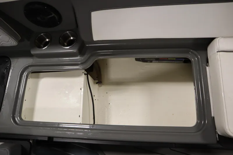Slide: The Image of 2022 Heyday H22 boat interior storage compartment with cup holders and speaker. - 34