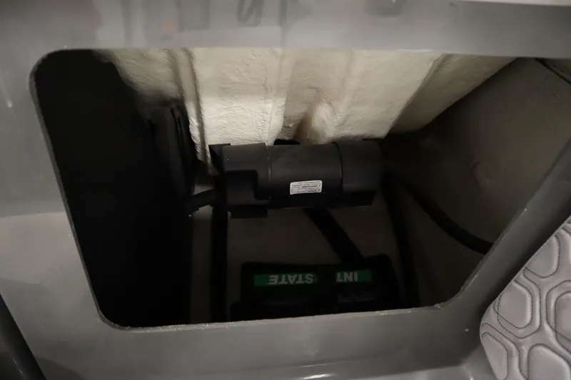 Slide: The Image of 2022 Heyday H22 boat battery compartment with visible wiring and insulation. - 36
