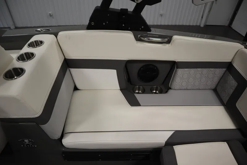 Slide: The Image of 2022 Heyday H22 boat interior with cushioned seating and cup holders. - 40