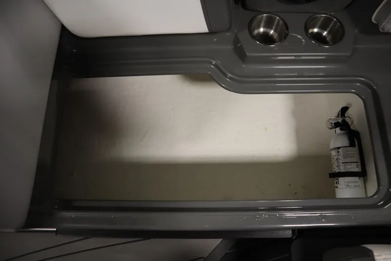 Slide: The Image of 2022 Heyday H22 boat storage area with fire extinguisher and cup holders. - 41