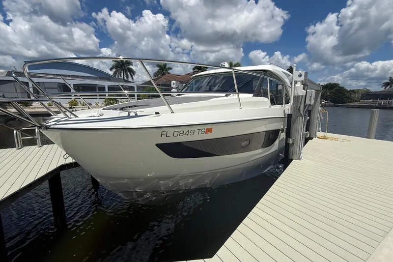 Slide: The Image of 2024 Beneteau Antares 11 docked under a partly cloudy sky. - 1