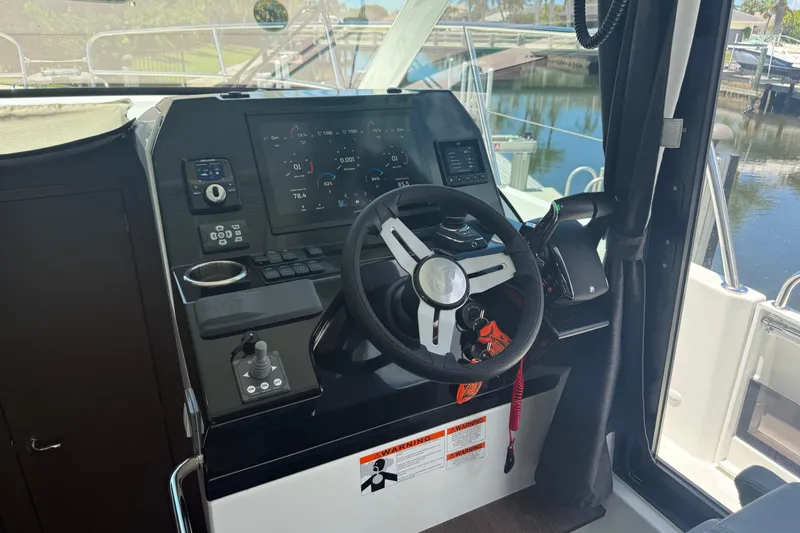 Slide: The Image of 2024 Beneteau Antares 11 helm with modern controls and navigation display. - 18