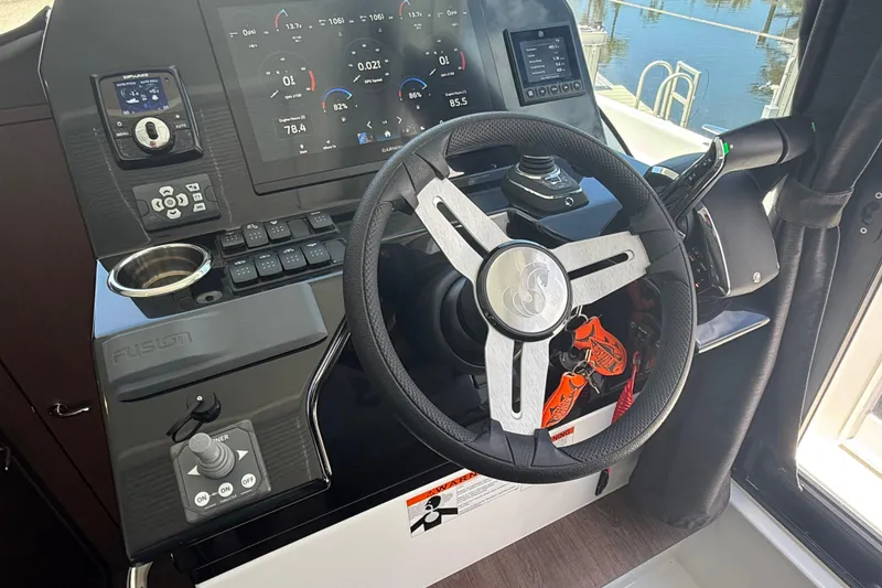 Slide: The Image of 2024 Beneteau Antares 11 helm with modern controls and navigation display. - 19