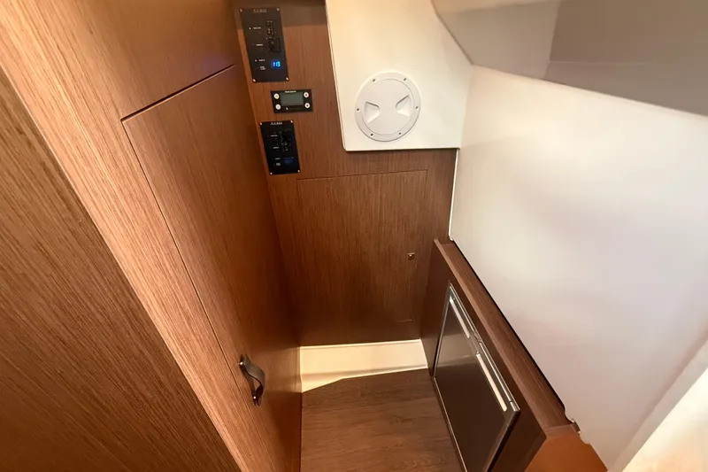 Slide: The Image of 2024 Beneteau Antares 11 interior with wood paneling and control panels. - 21