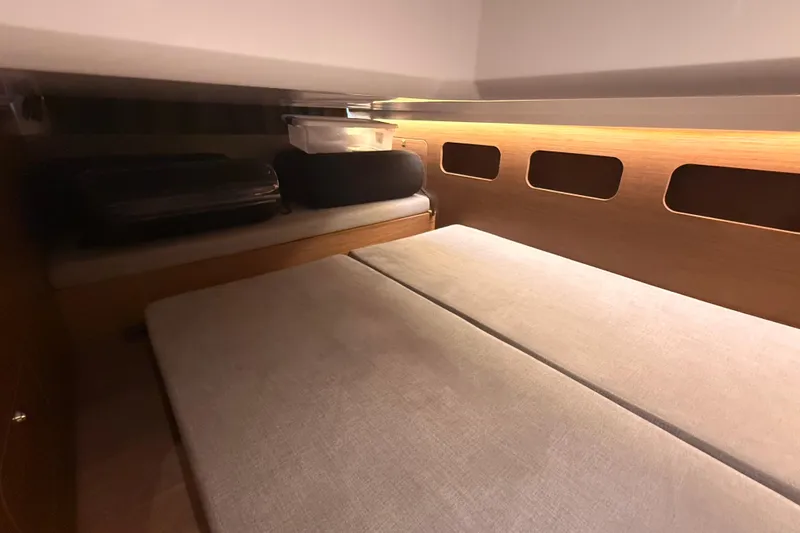 Slide: The Image of 2024 Beneteau Antares 11 cabin interior with cozy bedding and storage space. - 28
