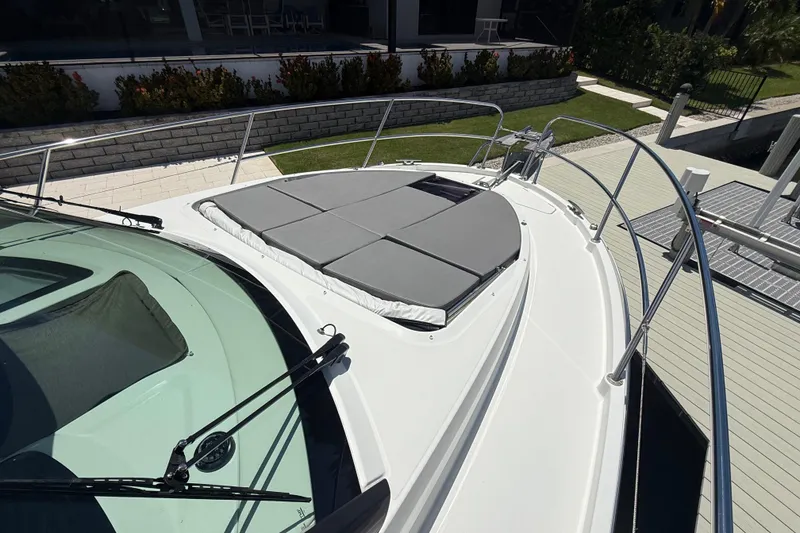 Slide: The Image of 2024 Beneteau Antares 11 boat deck with sunbathing area and sleek design. - 4