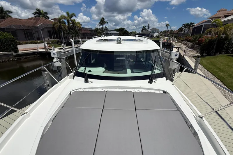 Slide: The Image of 2024 Beneteau Antares 11 yacht docked, featuring spacious deck and sleek design. - 5