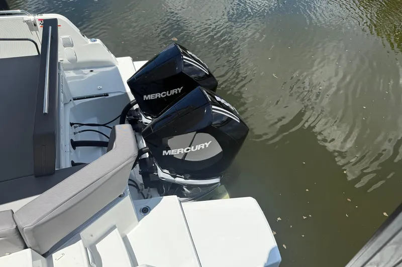 Slide: The Image of 2024 Beneteau Antares 11 with dual Mercury outboard engines on calm water. - 9