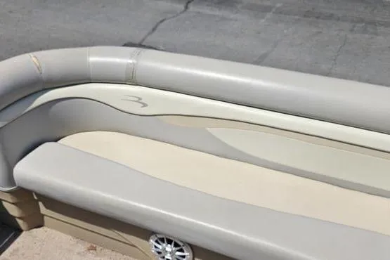 Slide: The Image of 2013 Bennington 20SLX boat interior with beige seating and speaker detail. - 12