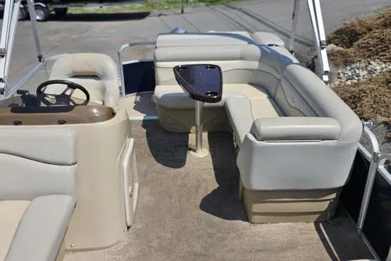 Slide: The Image of 2013 Bennington 20SLX pontoon boat interior with beige seating and steering console. - 13