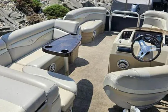 Slide: The Image of 2013 Bennington 20SLX pontoon boat interior with beige seating and steering console. - 4
