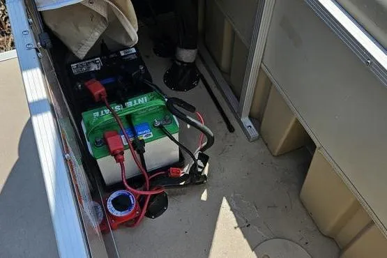 Slide: The Image of Battery setup inside a 2013 Bennington 20SLX boat, featuring cables and compartments. - 5