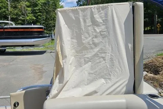 Slide: The Image of 2013 Bennington 20SLX boat with a privacy curtain, parked outdoors. - 6
