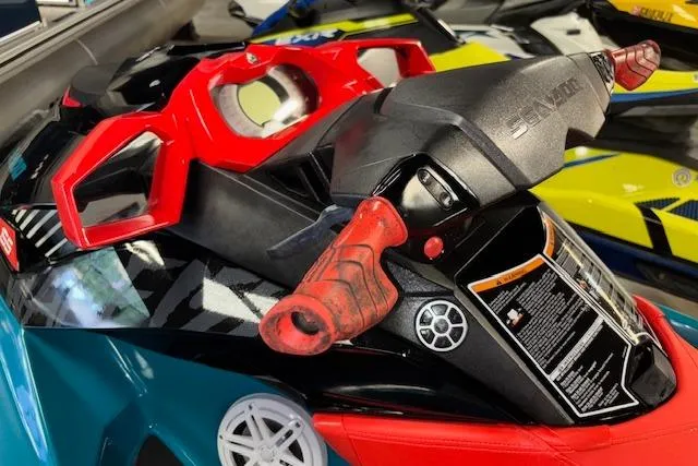 Slide: The Image of 2018 Sea-Doo Wake 155 jet ski with vibrant red and black handlebars. - 11