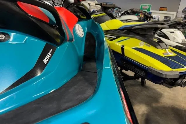 Slide: The Image of 2018 Sea-Doo Wake 155 jet ski in showroom, featuring vibrant colors and sleek design. - 14